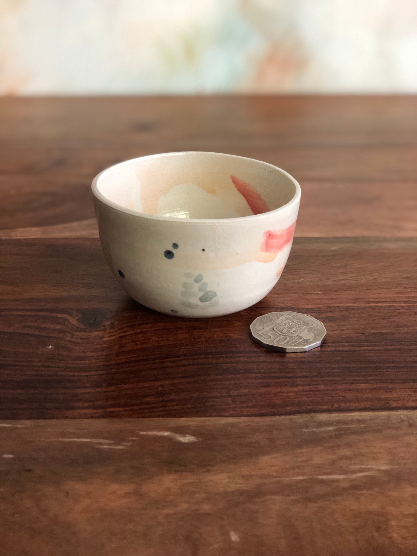 Tiny painted cup or bowl (candle optional)