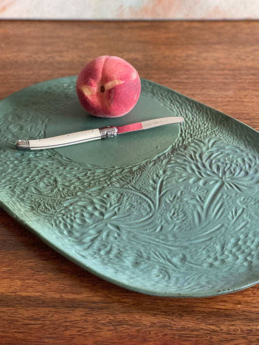 Large carved green oval platter