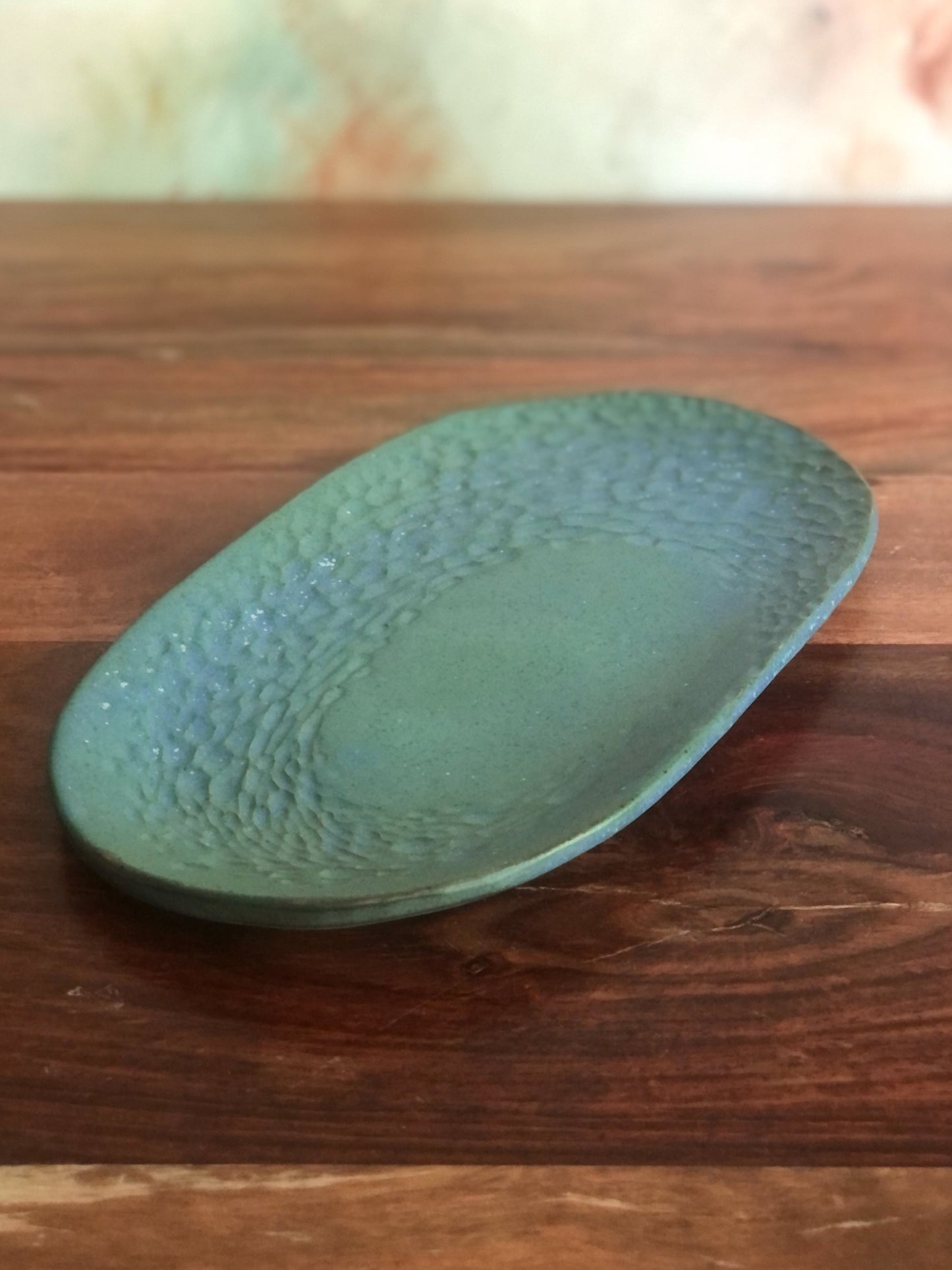 Small carved green oval plate